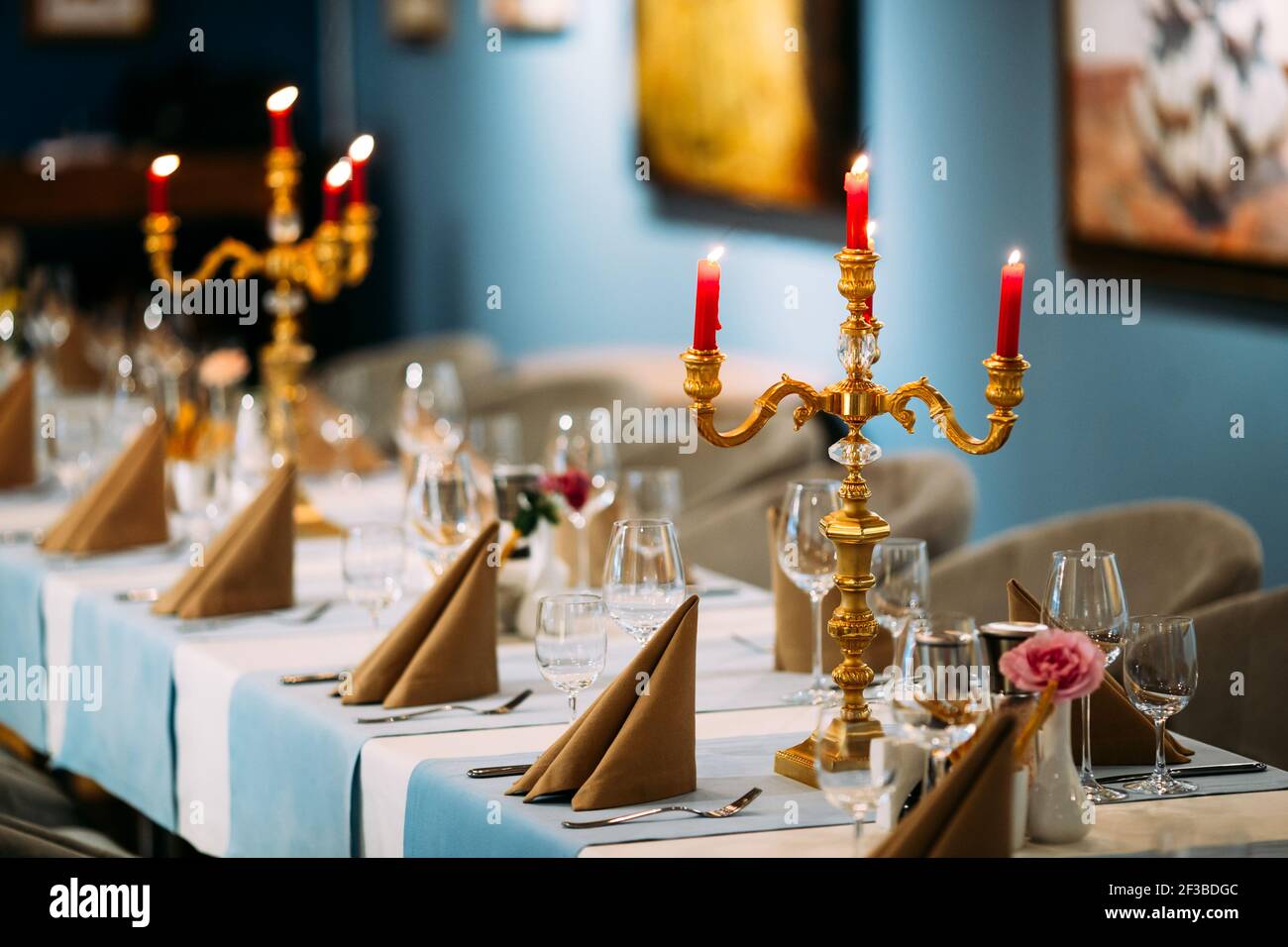 Exquisite restaurant table with candles and flower Stock Photo