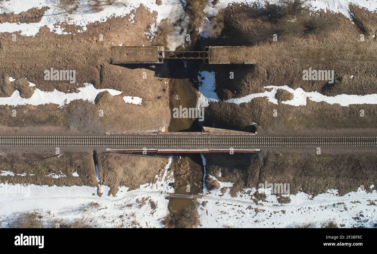Railroad bridge over small river above drone top view Stock Photo