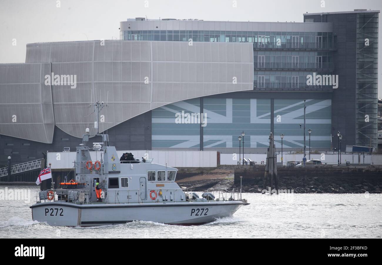 The Royal Navy archer class patrol vessel HMS Smiter passes the headquarters of Ineos Team UK as she makes her way out to sea. . Picture date: Tuesday March 16, 2021. Stock Photo