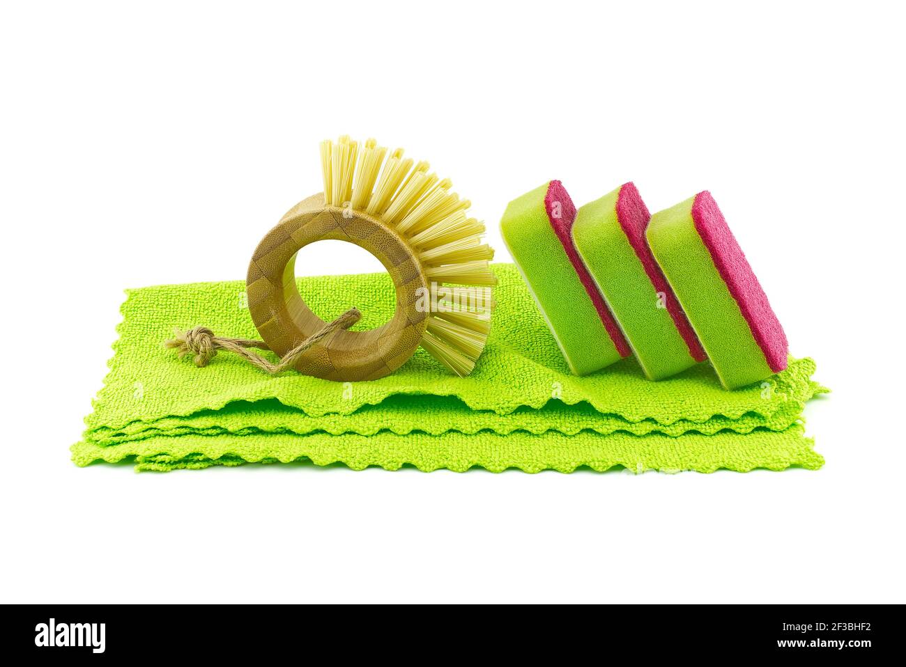 Multicolored cleaning sponges and dish brushes on microfiber cloth isolated on a white background. House cleaning supplies Stock Photo
