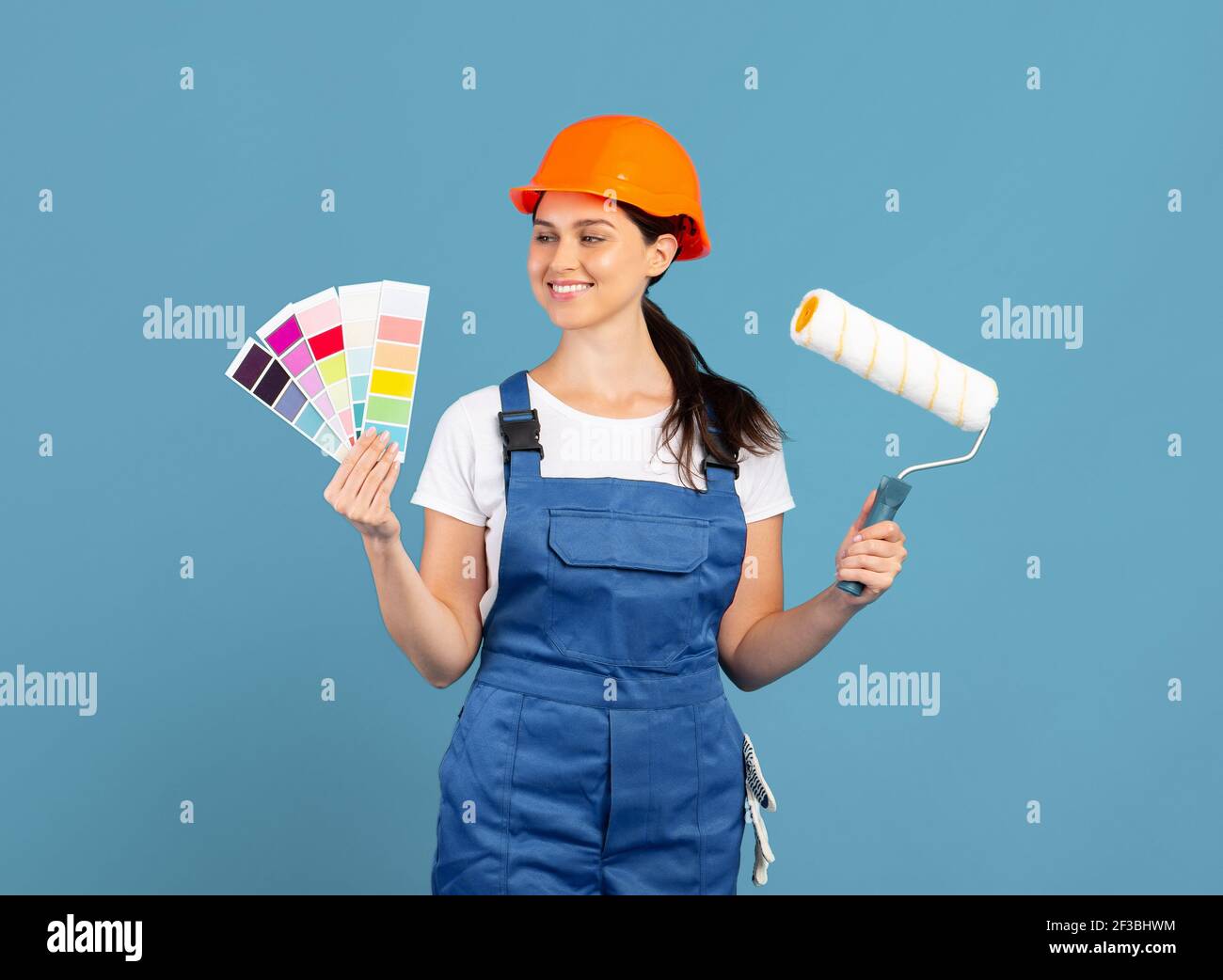 Female painter holding roller brush hi-res stock photography and images ...