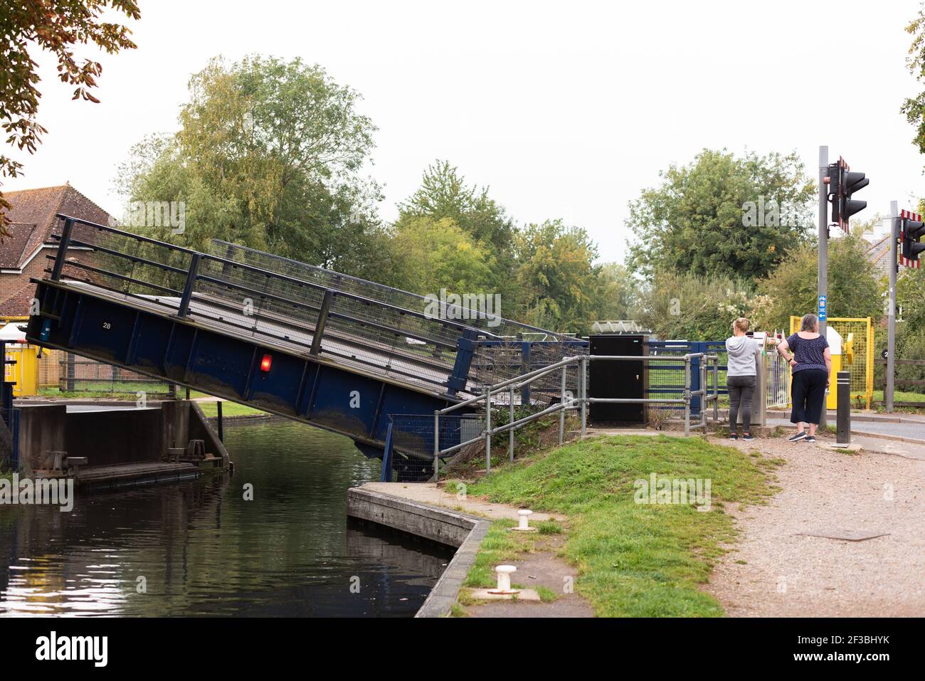 electric draw bridge on canal being opened to let boat through Stock Photo