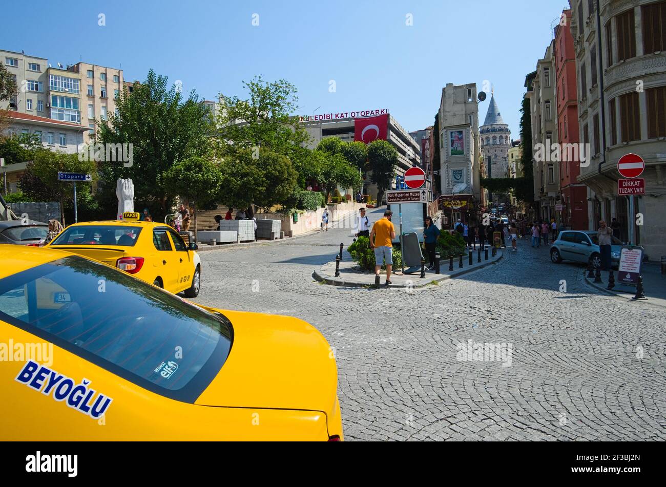 Istanbul, Turkey - September, 2018: Yellow taxi cabs near the square near Galata Tower in Beyoglu district. Taxi with Beyoglu name sign. Stock Photo
