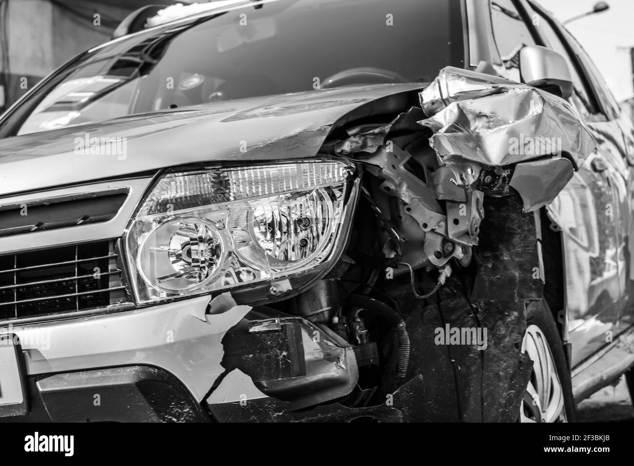 Damaged car detail on crushed car, wrecked vehicle. Crushed metal and