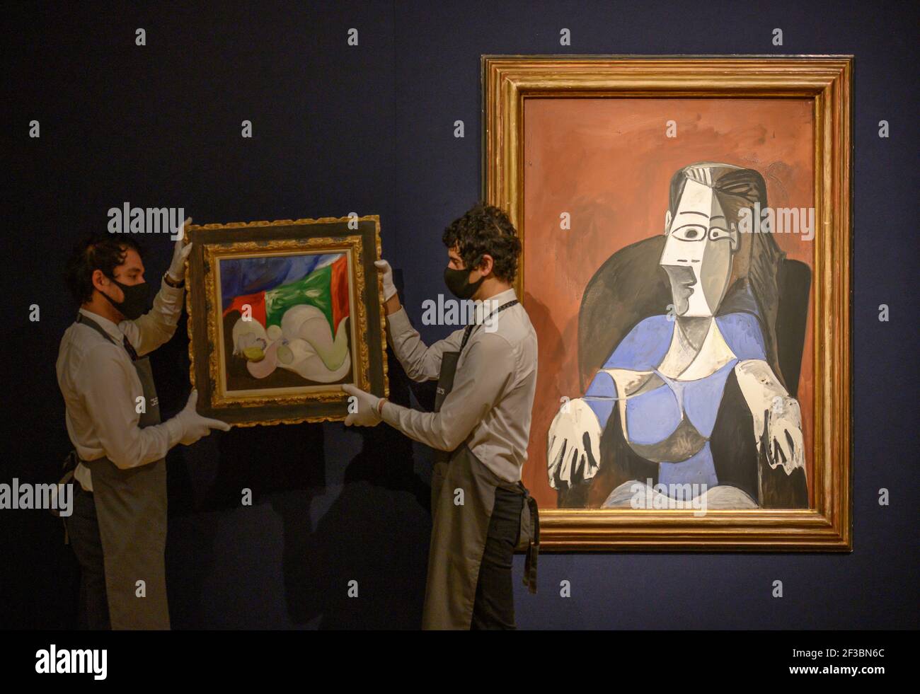 Christies, London, UK. 16 March 2021. Preparations behind closed doors for the livestreamed 20th Century Art evening sale and The Art of the Surreal sale 23 March. The sale is led by Pablo Picasso’s Femme nue couchée au collier (Marie-Therese), (1932), estimate of £9,000,000-£15,000,000, seen in front of Pablo Picasso, Femme assise dans un fauteuil noir (Jacqueline), (1962), estimate of £6,000,000-£9,000,000. Credit: Malcolm Park/Alamy Live News. Stock Photo
