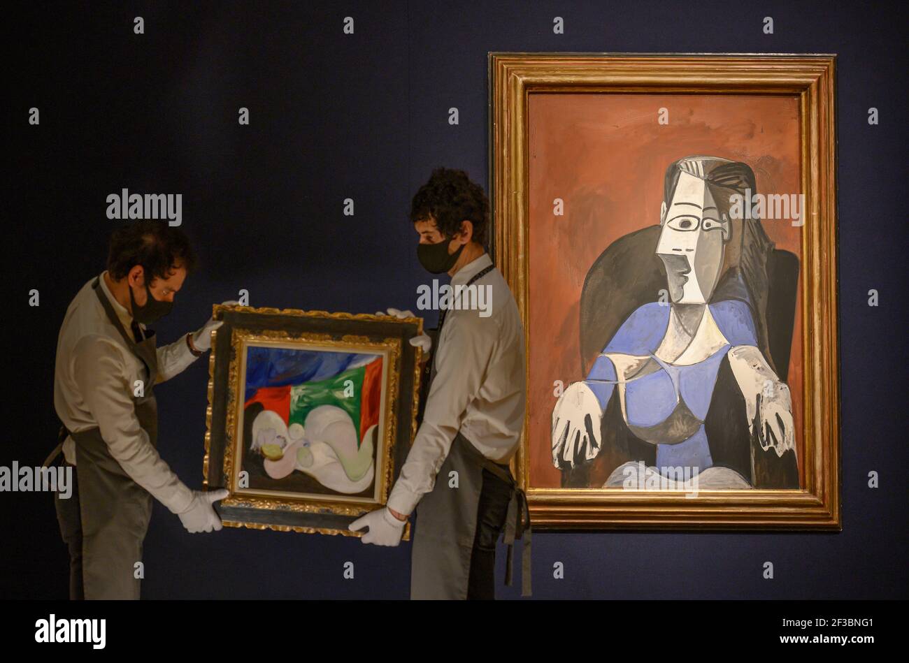 Christies, London, UK. 16 March 2021. Preparations behind closed doors for the livestreamed 20th Century Art evening sale and The Art of the Surreal sale 23 March. The sale is led by Pablo Picasso’s Femme nue couchée au collier (Marie-Therese), (1932), estimate of £9,000,000-£15,000,000, seen in front of Pablo Picasso, Femme assise dans un fauteuil noir (Jacqueline), (1962), estimate of £6,000,000-£9,000,000. Credit: Malcolm Park/Alamy Live News. Stock Photo