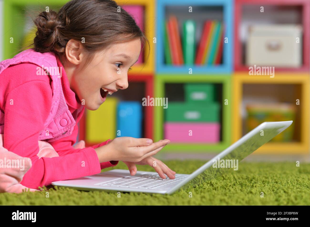 Close up portrait of emotional cute girl using laptop Stock Photo - Alamy