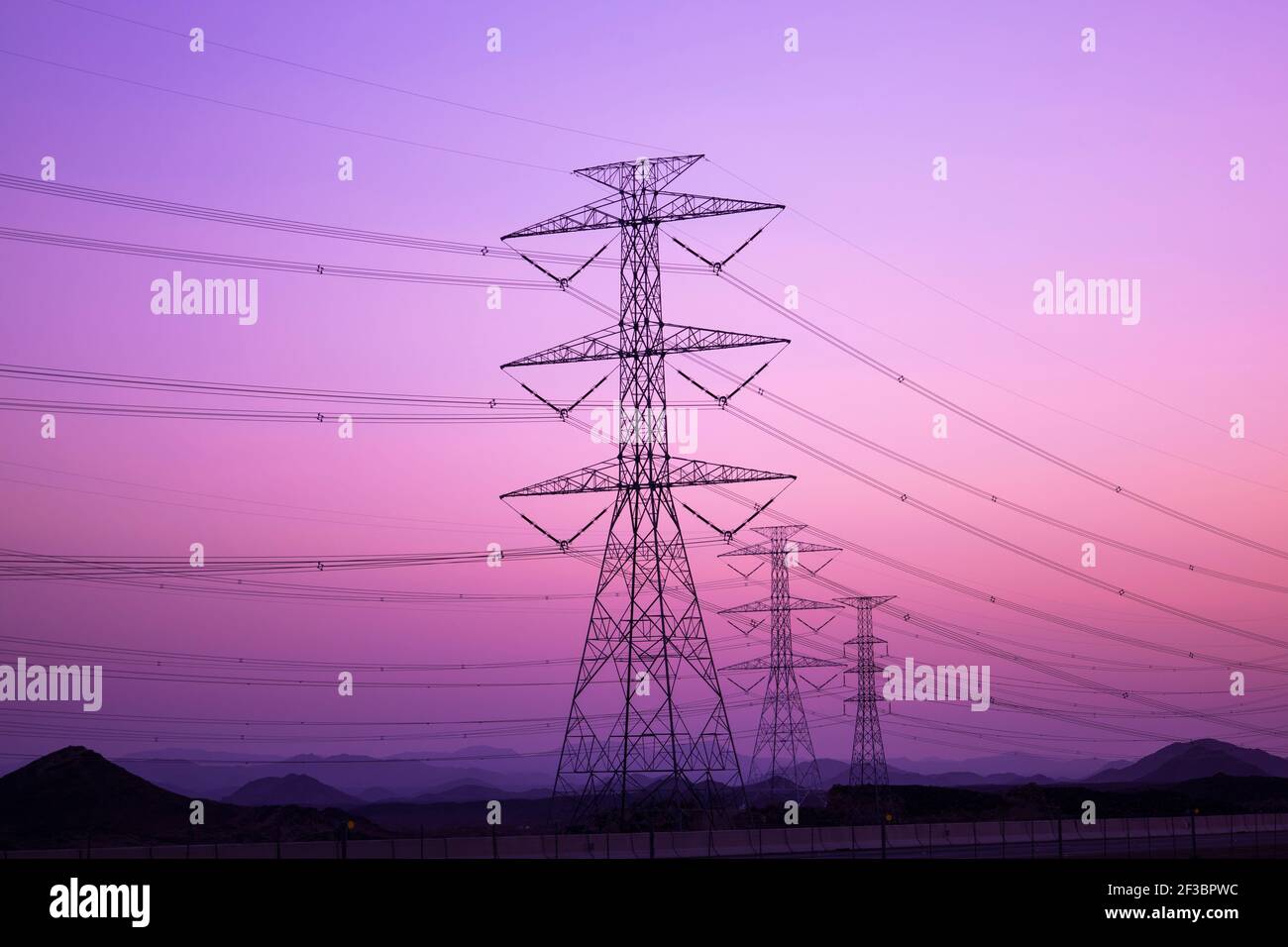 high-voltage electricity poles Tower - power station - distribute Electric energy , sunset Stock Photo