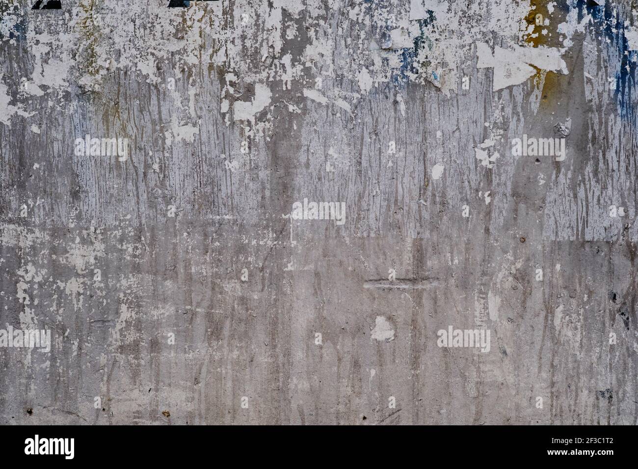 Old Bulleting Board Wall With Rests Of Worn Peeled Advertising Posters 