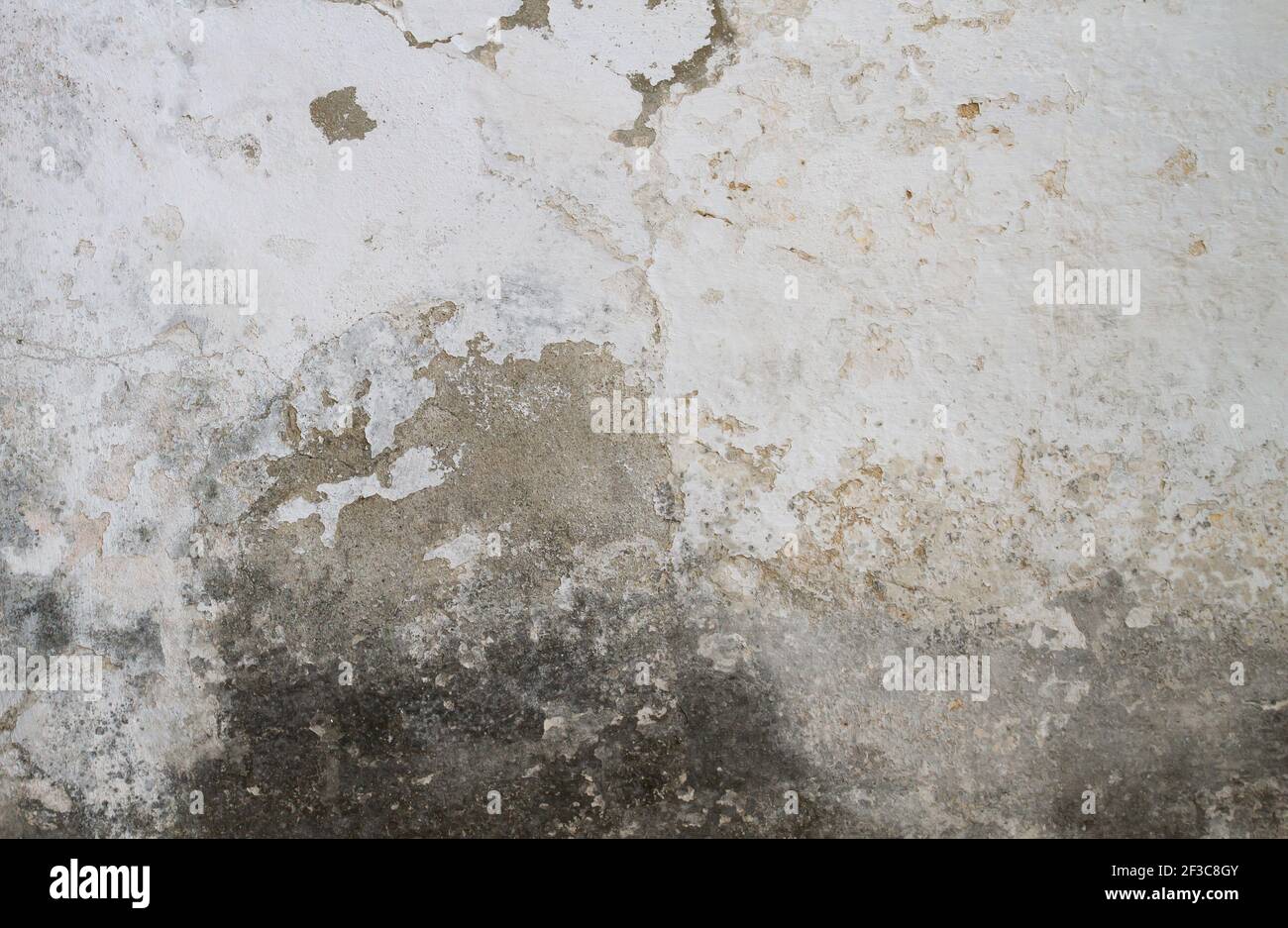 Old concrete wall with white peeling paint, grunge background or texture Stock Photo