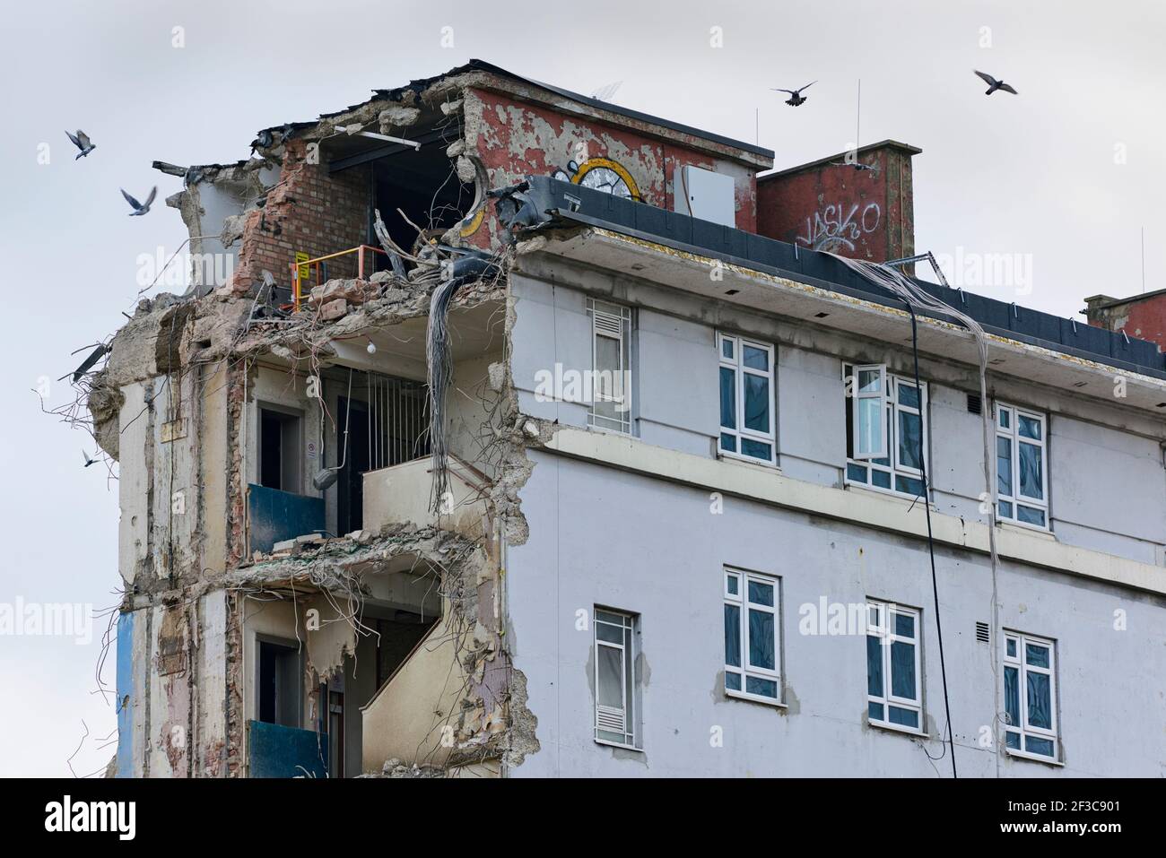 The top floors of a block of council flats under demolition during the redevelopment of Woodberry Down in the spring of 2021, Hackney, North London UK Stock Photo