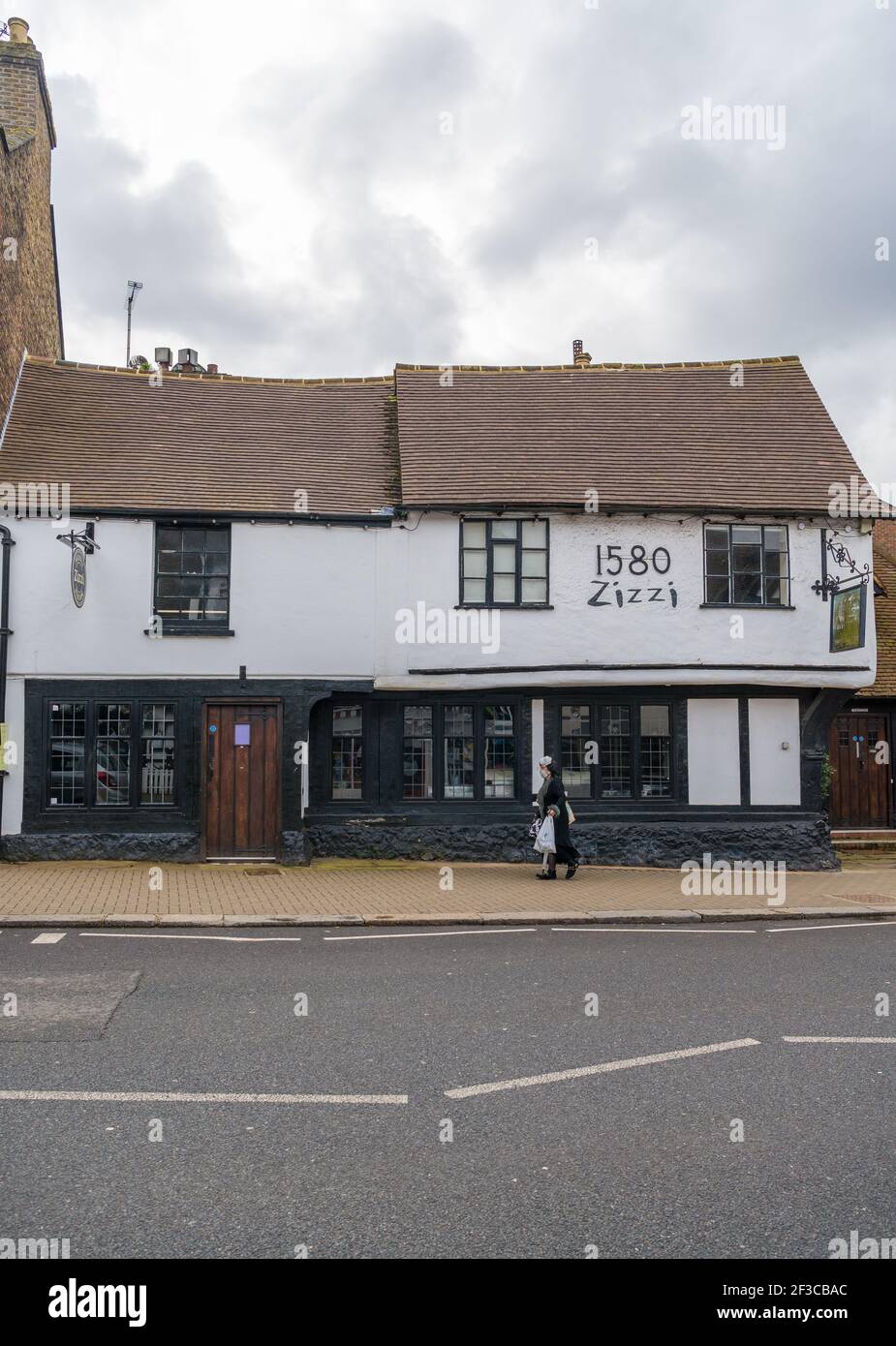 Woman walking past what was formerly The Victory pub, now a Zizzi