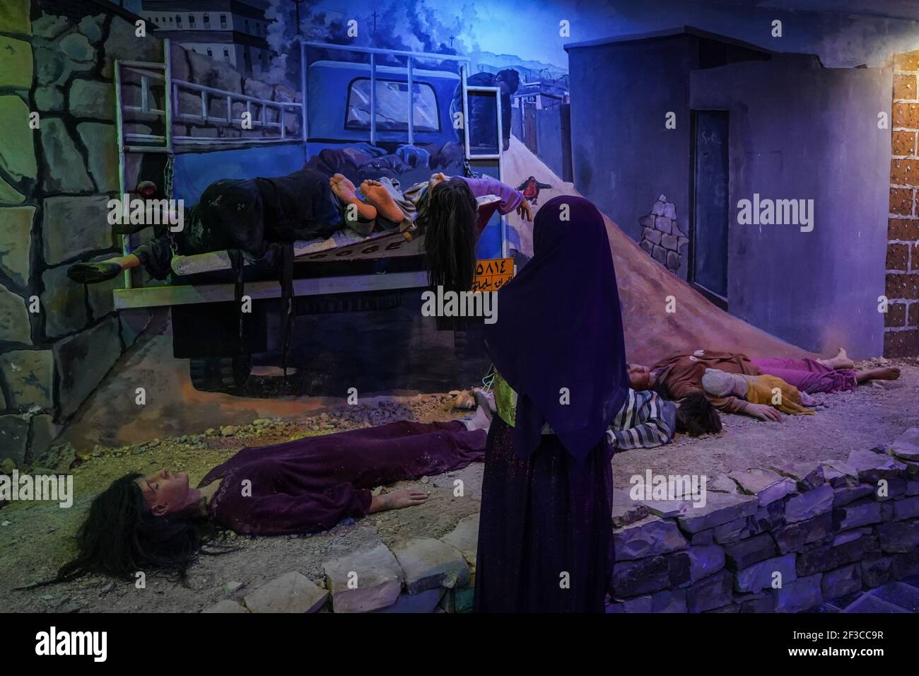 Halabja, Iraq. 16th Mar, 2021. A visitor of the Halabja Monument looks at a re-enactment scene of people who died in the chemical attack carried out by the Iraqi government on 16 March 1988 during the closing days of the Iran·Iraq War in the Kurdish city of Halabja, which killed nearly 5000 people and injured about 10000, most of them were civilians. Credit: Ismael Adnan/dpa/Alamy Live News Stock Photo