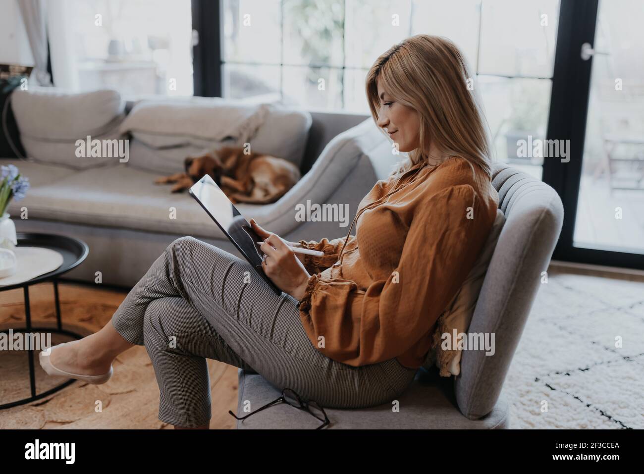 Businesswoman working at home and managing her business via home office during Coronavirus or Covid-19 quarantine Stock Photo