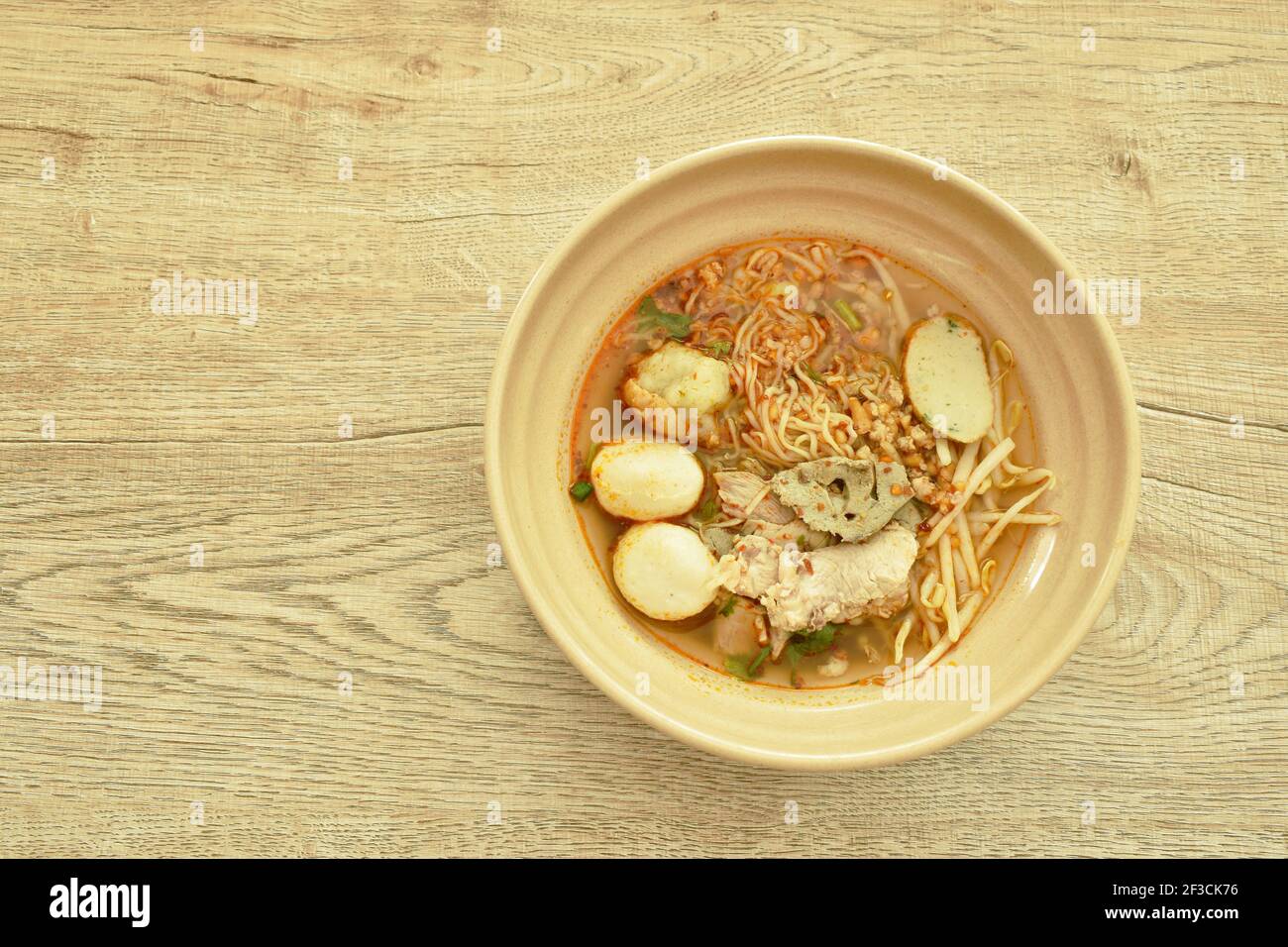Chinese egg yellow noodles topping slice boiled pork and ball in spicy