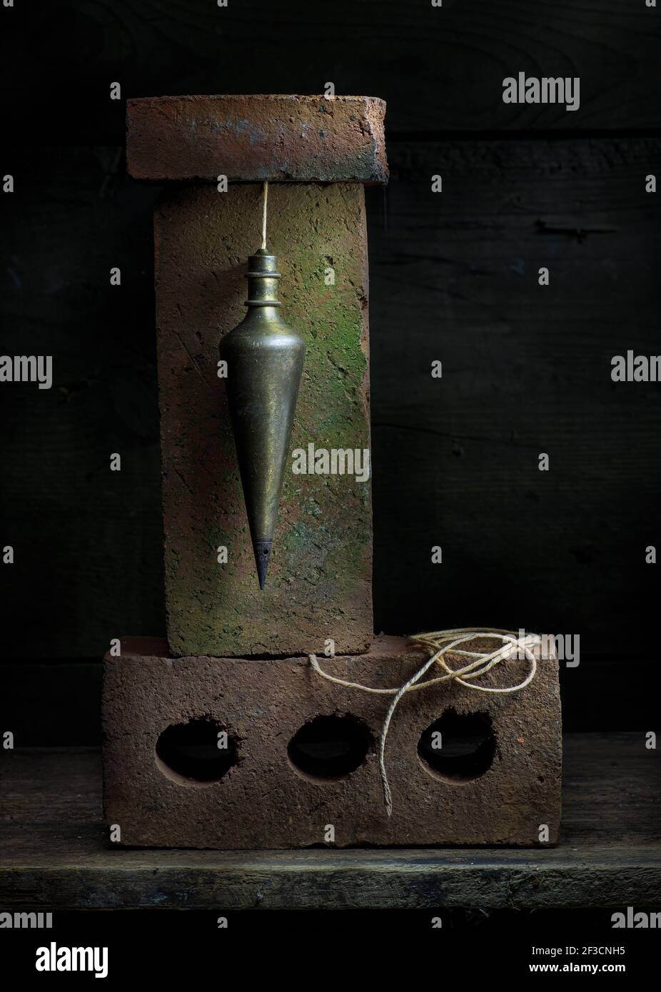 Old plumb bob and old bricks in still life Stock Photo Alamy