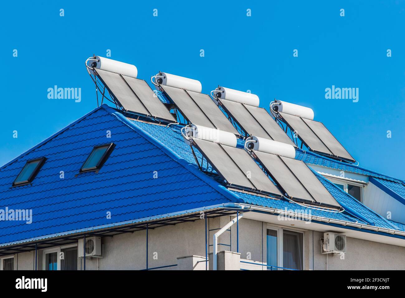 Solar water heater on the roof of a building against the background of ...