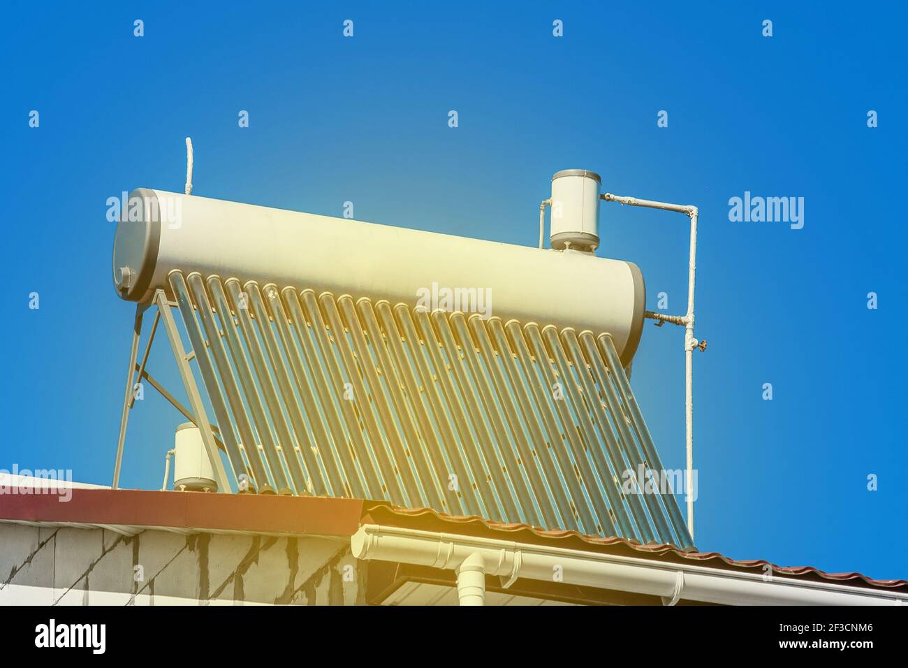 Solar water heater on the roof of a building against the background of ...