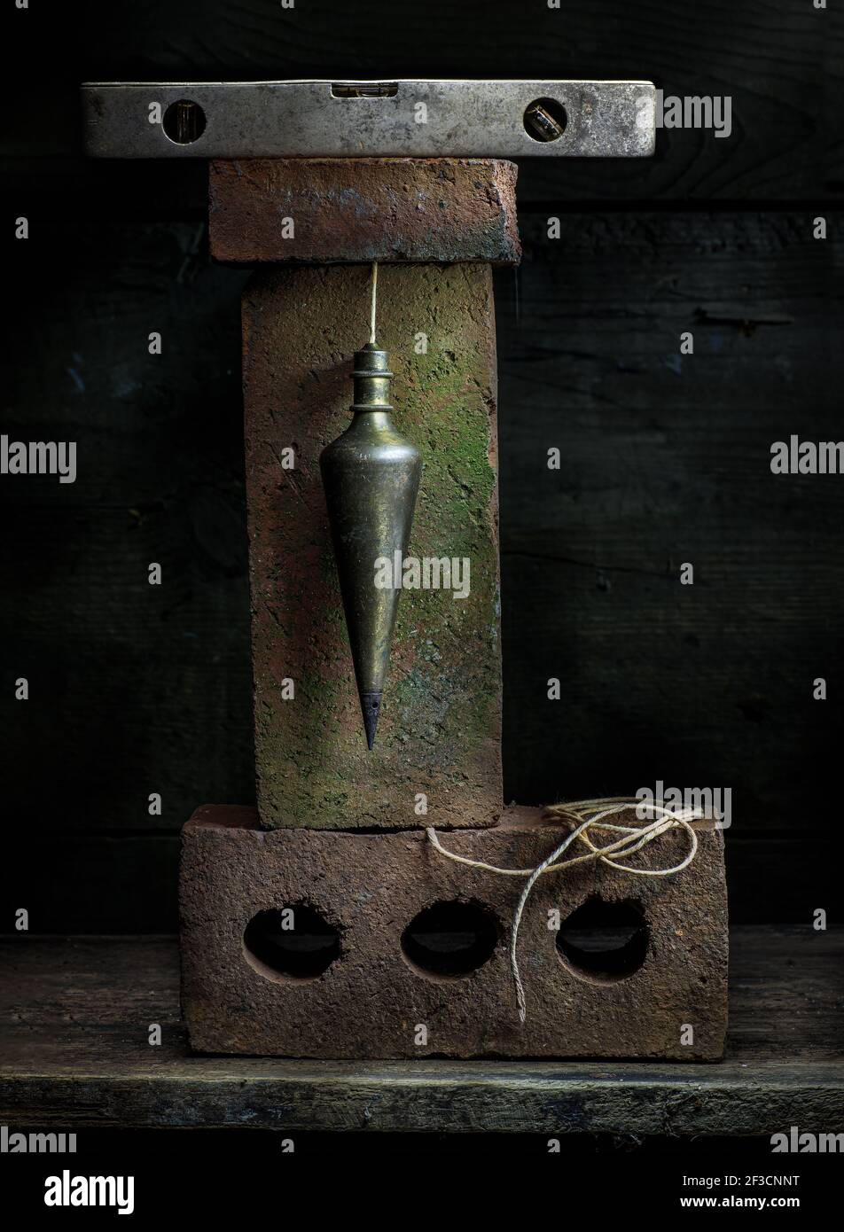 Old plumb bob and old bricks in still life Stock Photo Alamy