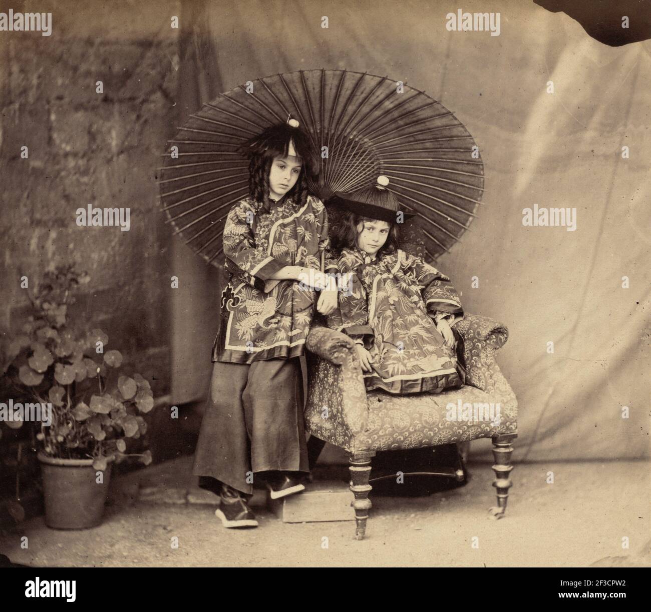 Lorina and Alice Liddell in Chinese Dress, 1860. Stock Photo