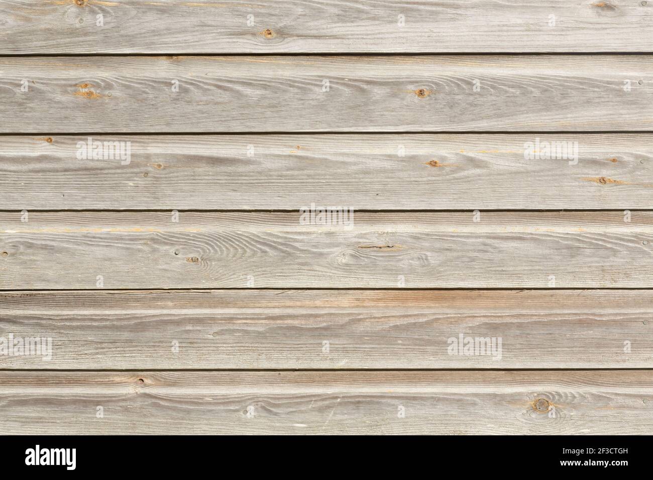Clapboard, wood siding, timber cladding on an old building exterior, UK. Faded, weathered oak Stock Photo