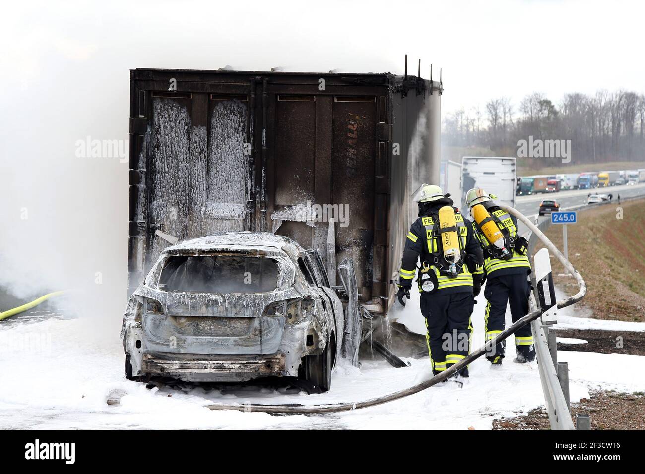 Bischbrunn, Germany. 16th Mar, 2021. Firefighters extinguish a vehicle after a fatal accident. On Tuesday morning, for reasons that have not yet been explained, a car hit a truck between the Rohrbrunn (Aschaffenburg district) and Marktheidenfeld junctions in the direction of Nuremberg, a police spokeswoman said. The A3 towards Würzburg had to be closed for hours because of this. Credit: Ralf Hettler/dpa/Alamy Live News Stock Photo