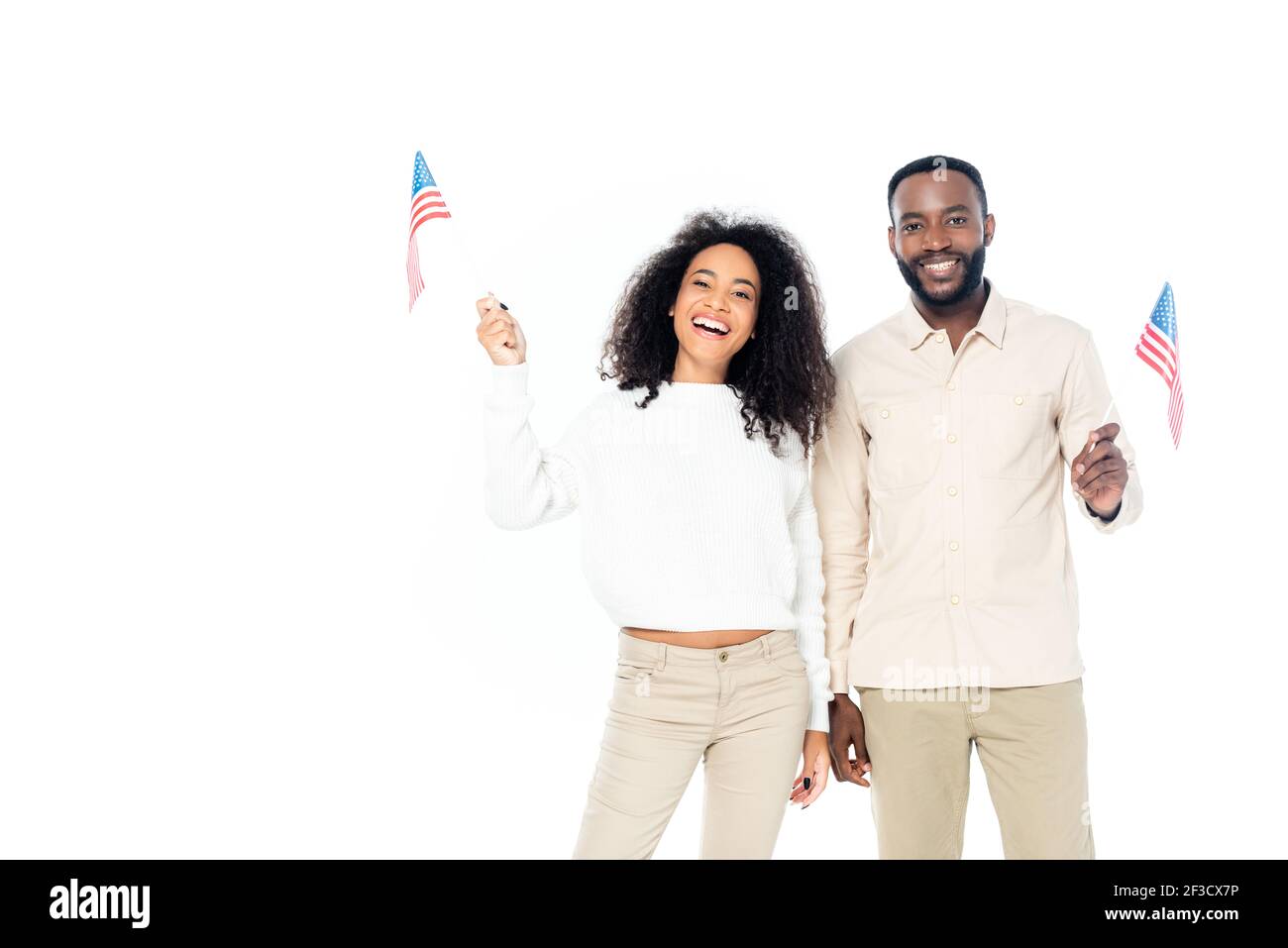 joyful african american couple smiling at camera while holding small flags of usa isolated on white Stock Photo