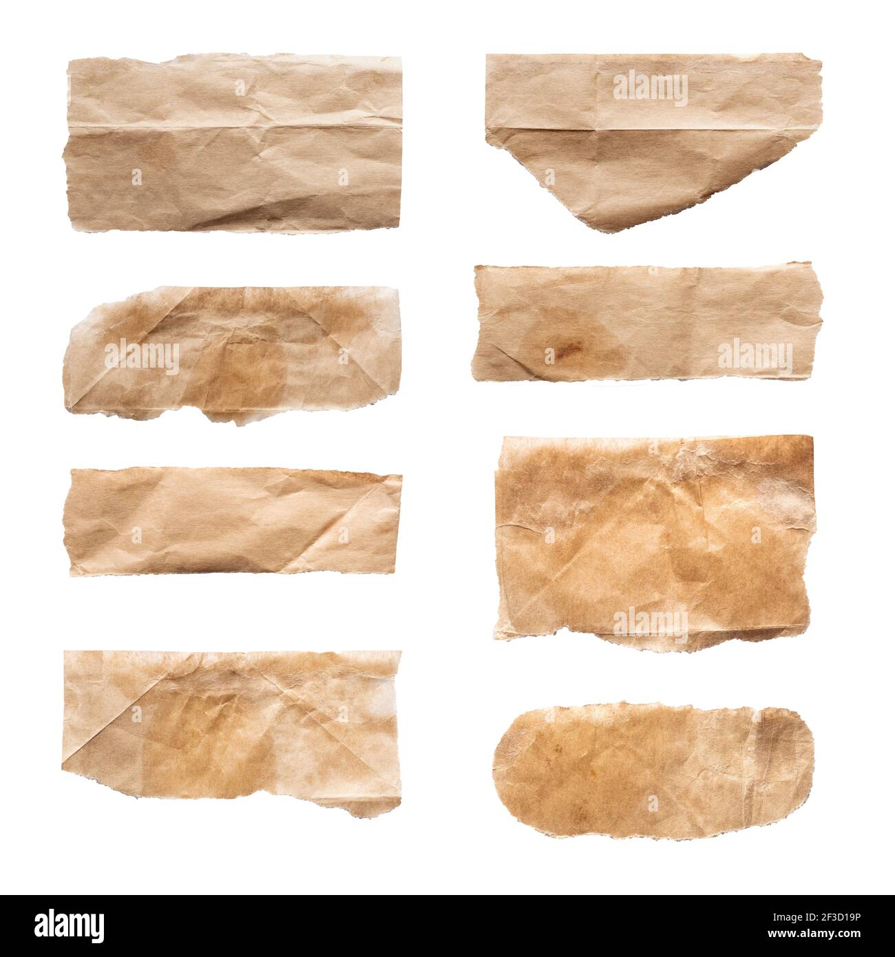 Close up of a ripped piece set of brown paper on white background Stock Photo