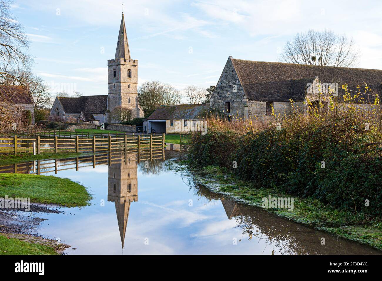 Floods by the River Severn - 29th November 2012 - the church and tithe barn reflected in the flood waters at Ashleworth, Gloucestershire, UK Stock Photo