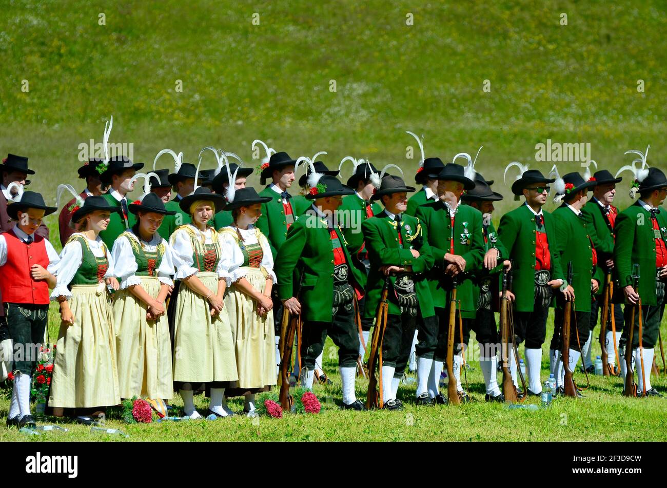 Feichten, Tyrol, Austria - June 22, 2014: Unidentified folklore group, Tyrolean gun men in traditional outfit and weapons by field mass in Kaunertal v Stock Photo