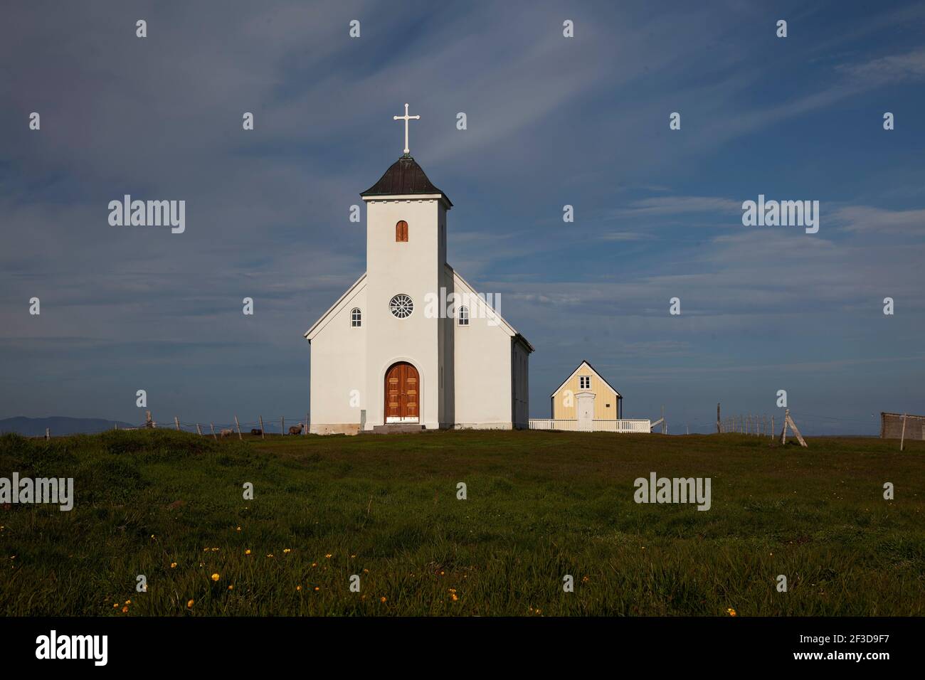 Flateyjarkirkja white Lutheran church with meadow is the only church on Flatey Island, Iceland Stock Photo