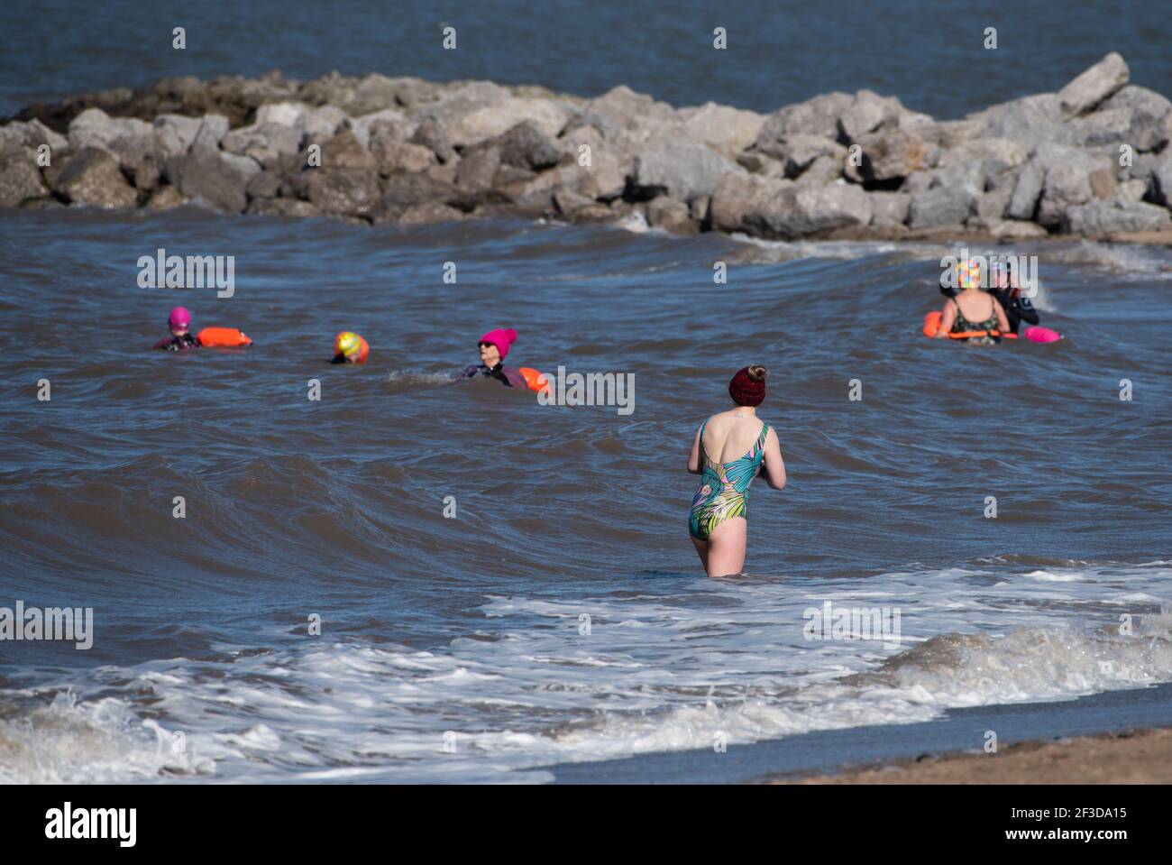 Morecambe, Lancashire, UK. 16th Mar, 2021. Members of open water swimming group MALLOWS (Morecambe and Lancaster Lancashire Open Water Swimming) enjoying the waters of Morecambe Bay at Morecambe, Lancashire. The group has grown from one member in 2017 to 2,900 members now enjoying a refreshing swim as an antidote to the pressures of the pandemic. Credit: John Eveson/Alamy Live News Stock Photo