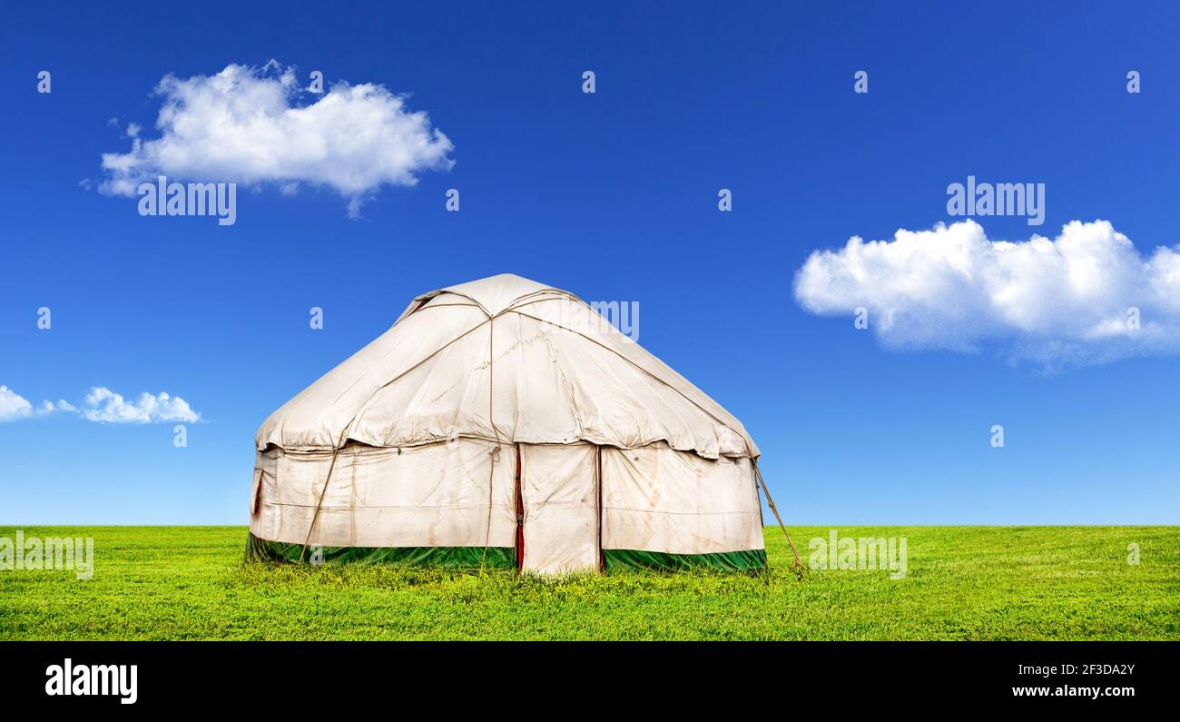 Yurt traditional nomadic house in central Asia on steppe at blue sky with clouds on Nauryz festival Stock Photo