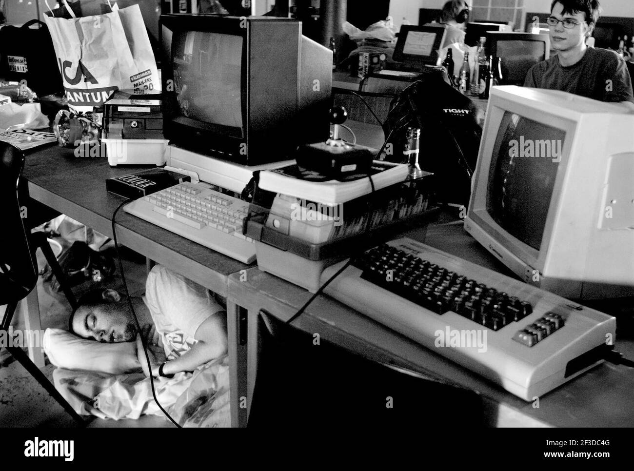 Game convention for Commodore 64 fans. Someone who fell asleep under a desk. Stock Photo