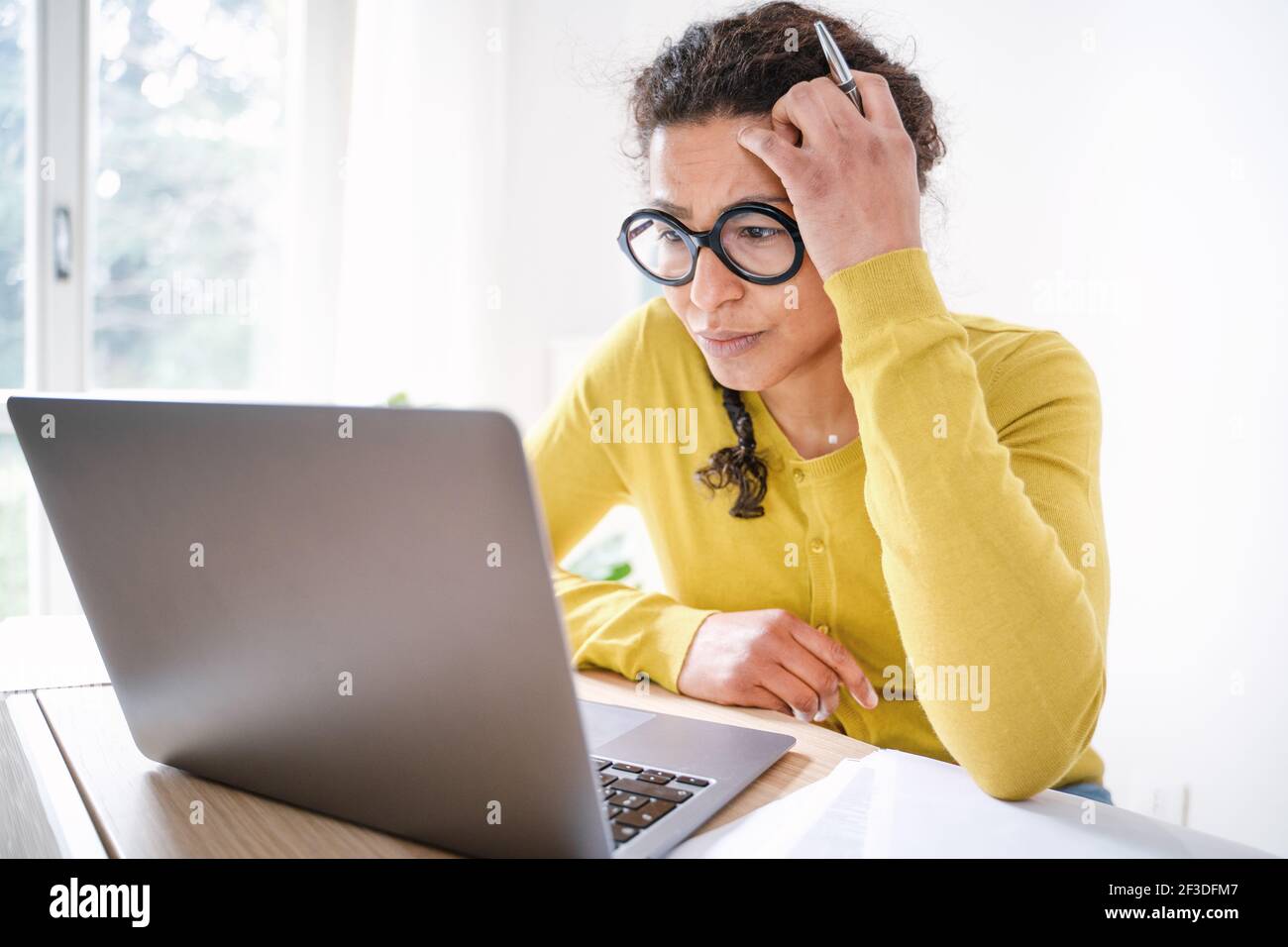 Black woman working hard on some project at computer Stock Photo