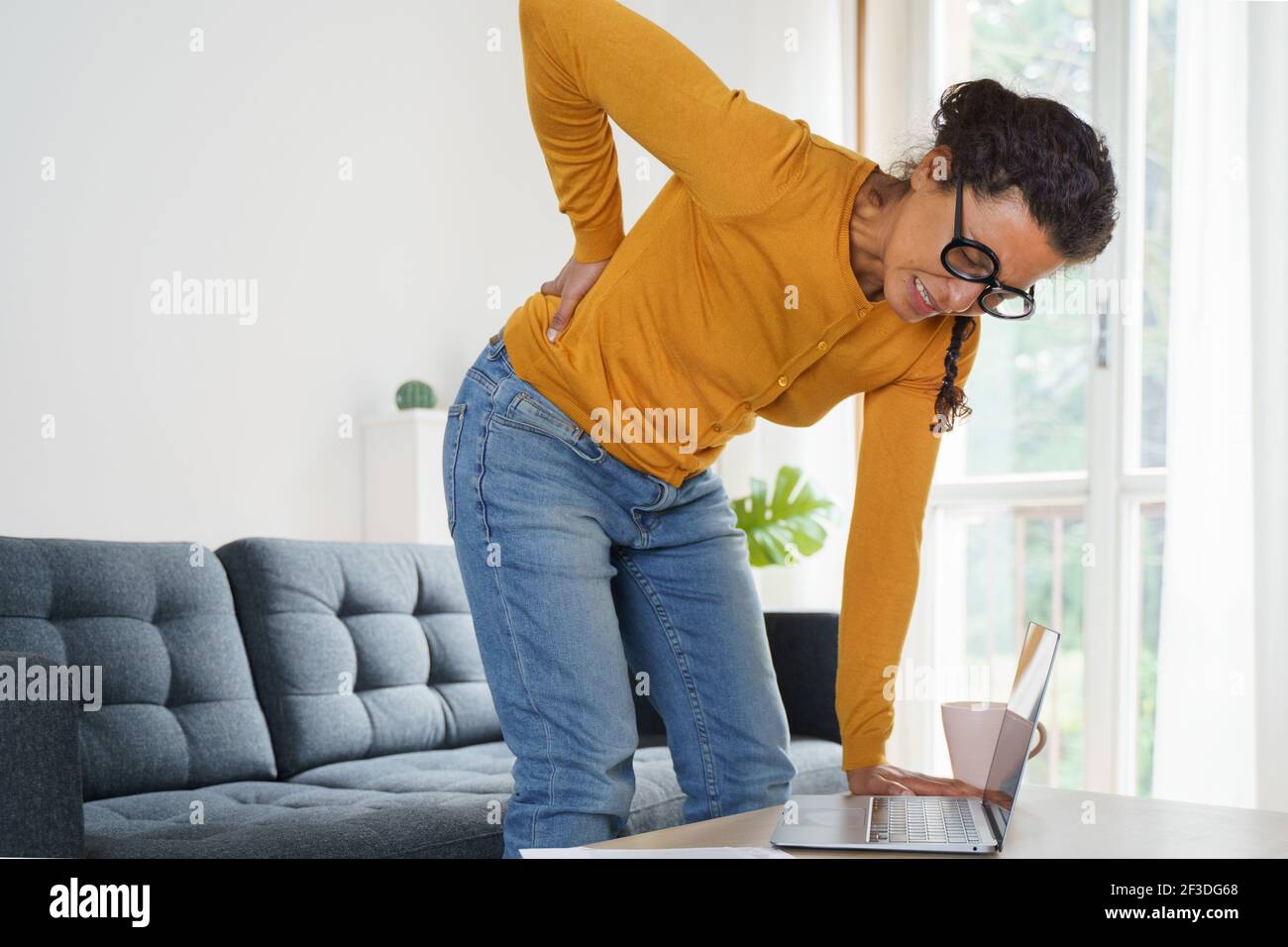 Woman is feeling back pain and Stock Photo Alamy