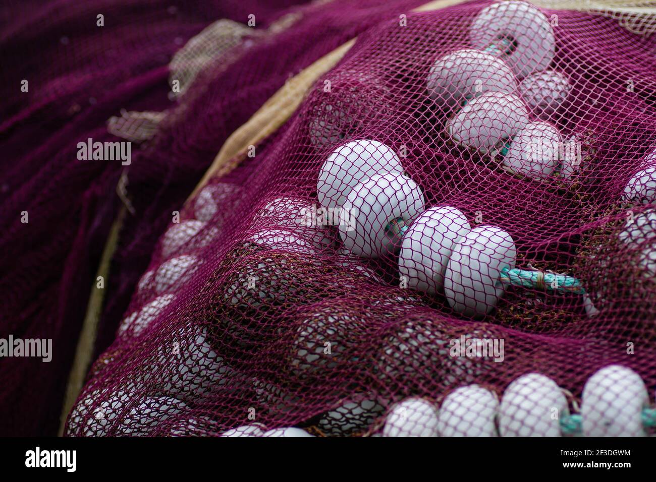 Old fishing nets pile with nets and floats Stock Photo - Alamy