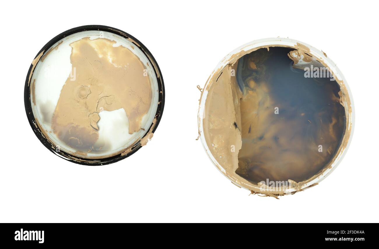 Top view of an open container of beige paint with the lid to the side that has not been mixed isolated on a white background. Stock Photo