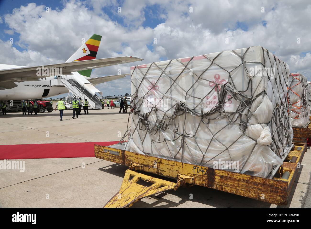 Harare, Zimbabwe. 16th Mar, 2021. COVID-19 vaccines are offloaded from a chartered Air Zimbabwe flight at Robert Gabriel Mugabe International Airport in Harare, Zimbabwe, March 16, 2021. Zimbabwe on Tuesday received a second batch of Sinopharm doses donated by China plus an additional Sinovac doses commercially procured by the government. Credit: Zhang Yuliang/Xinhua/Alamy Live News Stock Photo