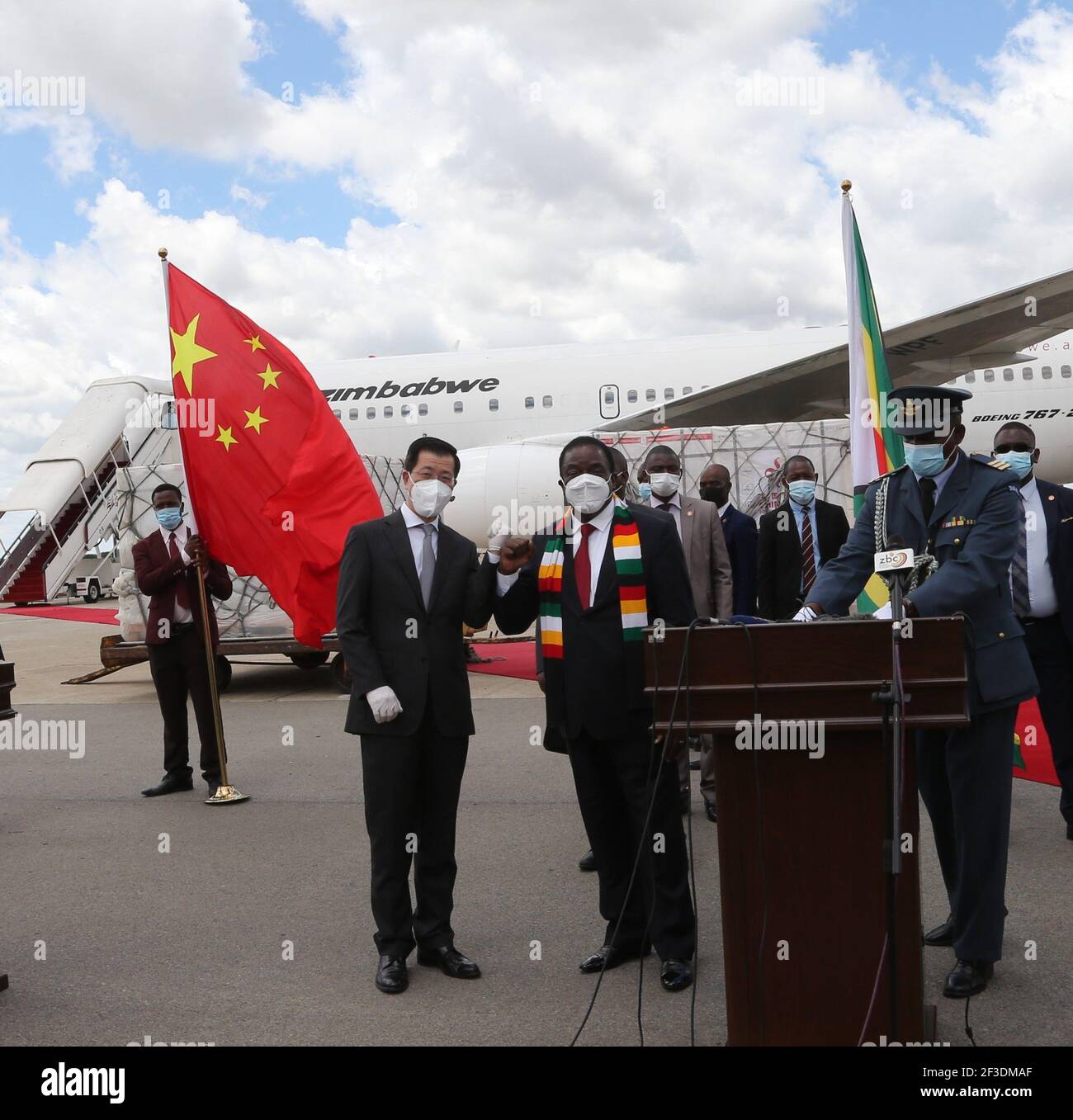 Harare, Zimbabwe. 16th Mar, 2021. Zimbabwean President Emmerson Mnangagwa (2nd L, front) and Chinese Ambassador to Zimbabwe Guo Shaochun (1st L, front) pose for a photo as a batch of COVID-19 vaccines arrive at Robert Gabriel Mugabe International Airport in Harare, Zimbabwe, on March 16, 2021. Zimbabwe on Tuesday received a second batch of Sinopharm doses donated by China plus an additional Sinovac doses commercially procured by the government. Credit: Zhang Yuliang/Xinhua/Alamy Live News Stock Photo