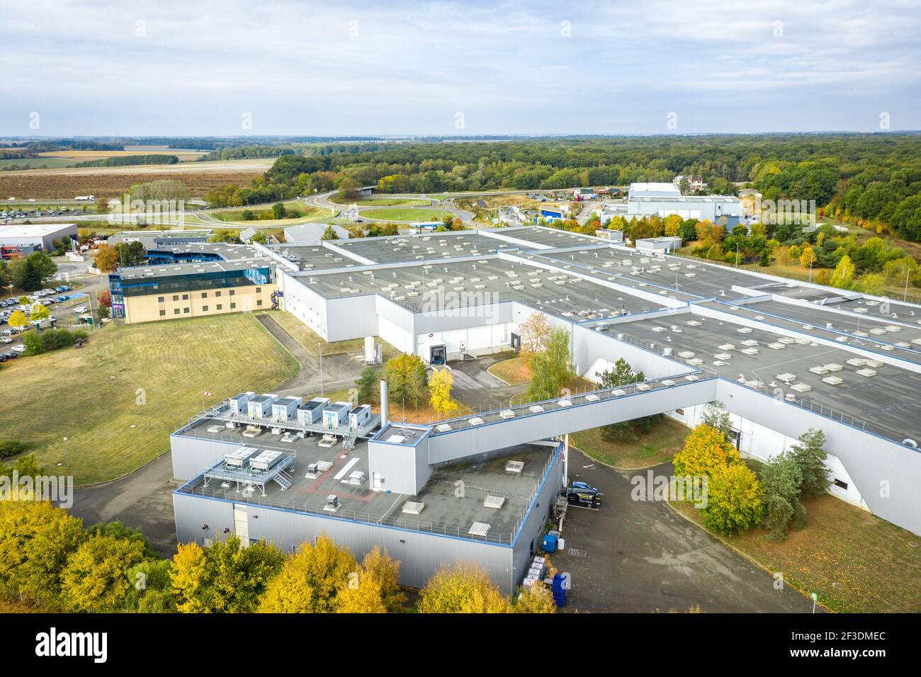 Drone view on modern warehouse hall in industrial zone. Two buildings connected with bridge. Industry, transport and logistics. Stock Photo