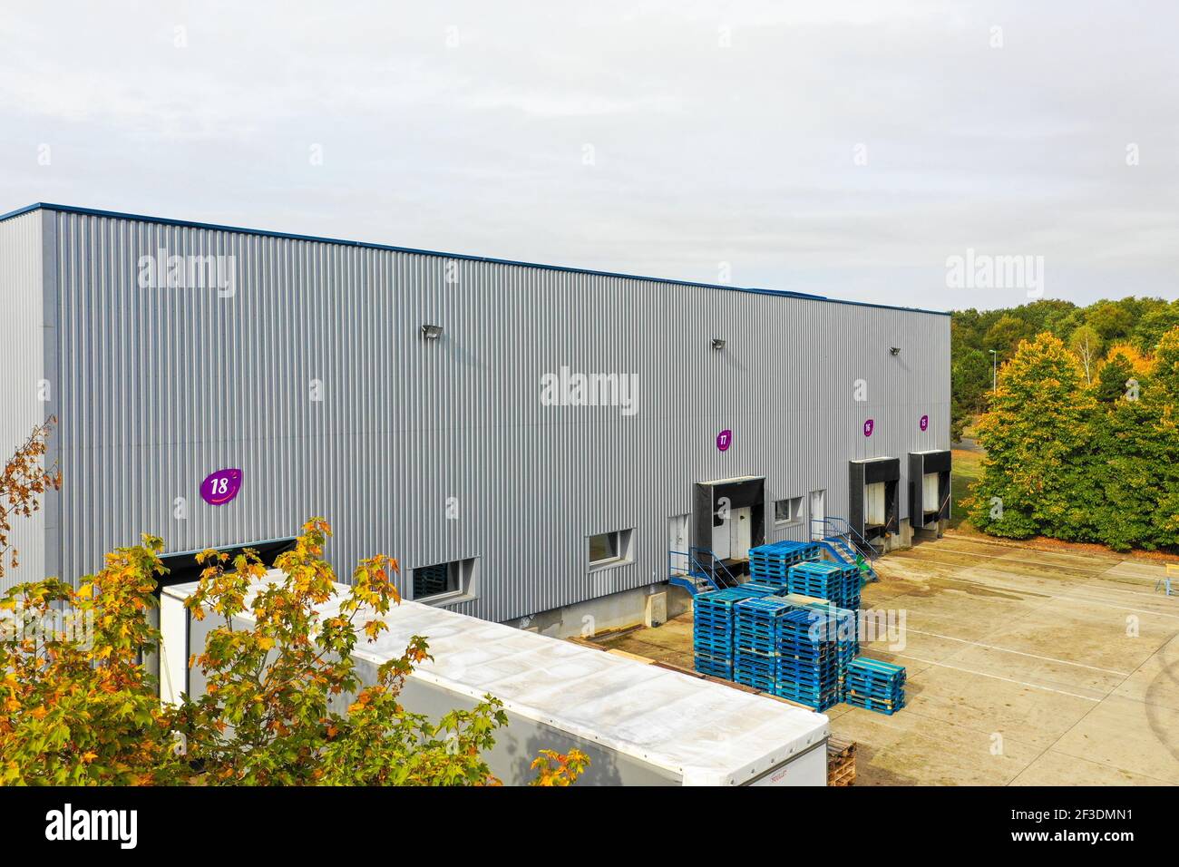 Striped wall of logistic or production hall with loading bays. Stacked ...