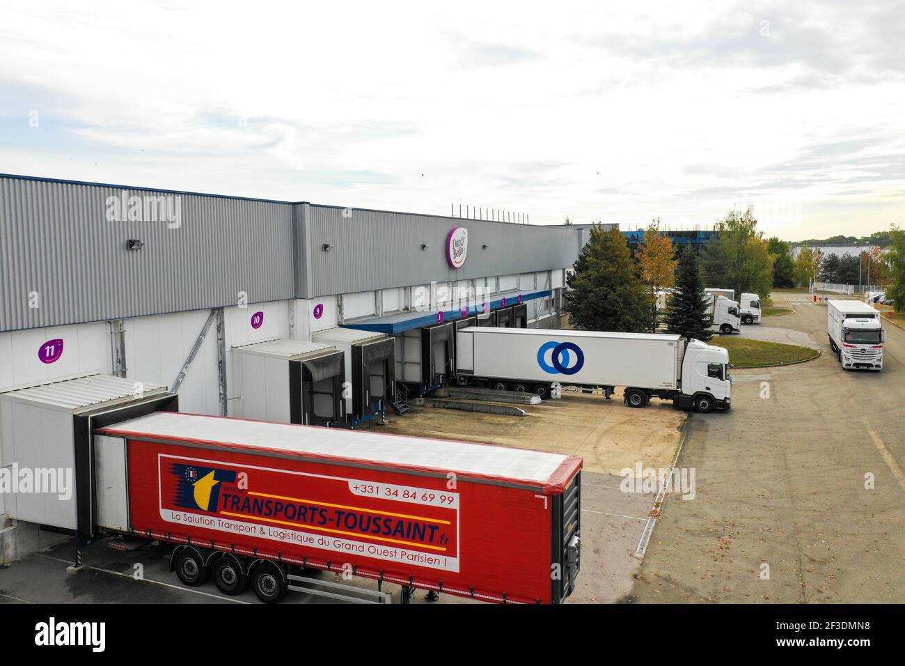 Trailers standing at warehouse loading bays. Loading or unloading of material and products. Industry, transport and logistics. Stock Photo