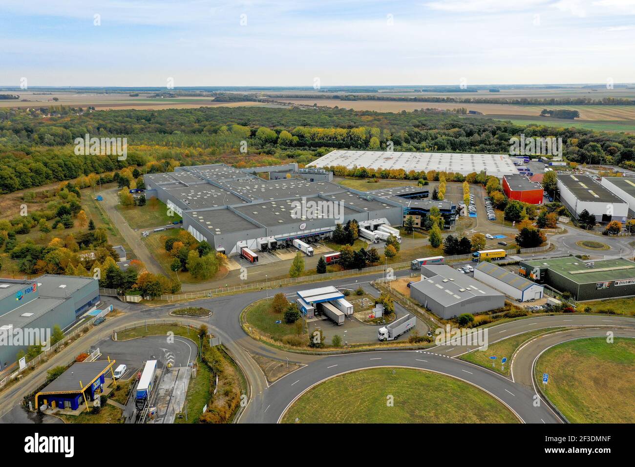 Aerial view of halls in industrial or logistic park. Modern warehouse or production buildings from drone. Industry, transport and logistics. Stock Photo