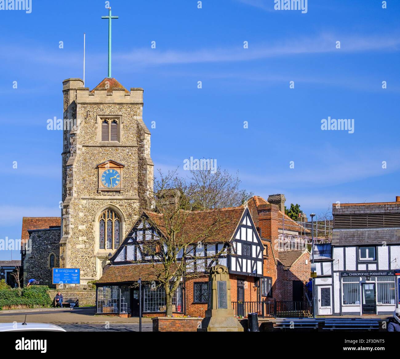 Pinner Village high street with medieval hilltop church St John the Baptist, war memorial & historic half-timbered buildings. NW London, England Stock Photo