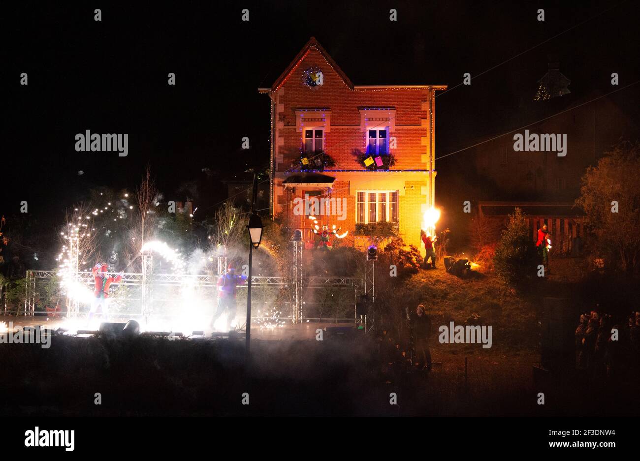 two male performers in santa dress on stage with silver fireworks in Saint quirin Stock Photo