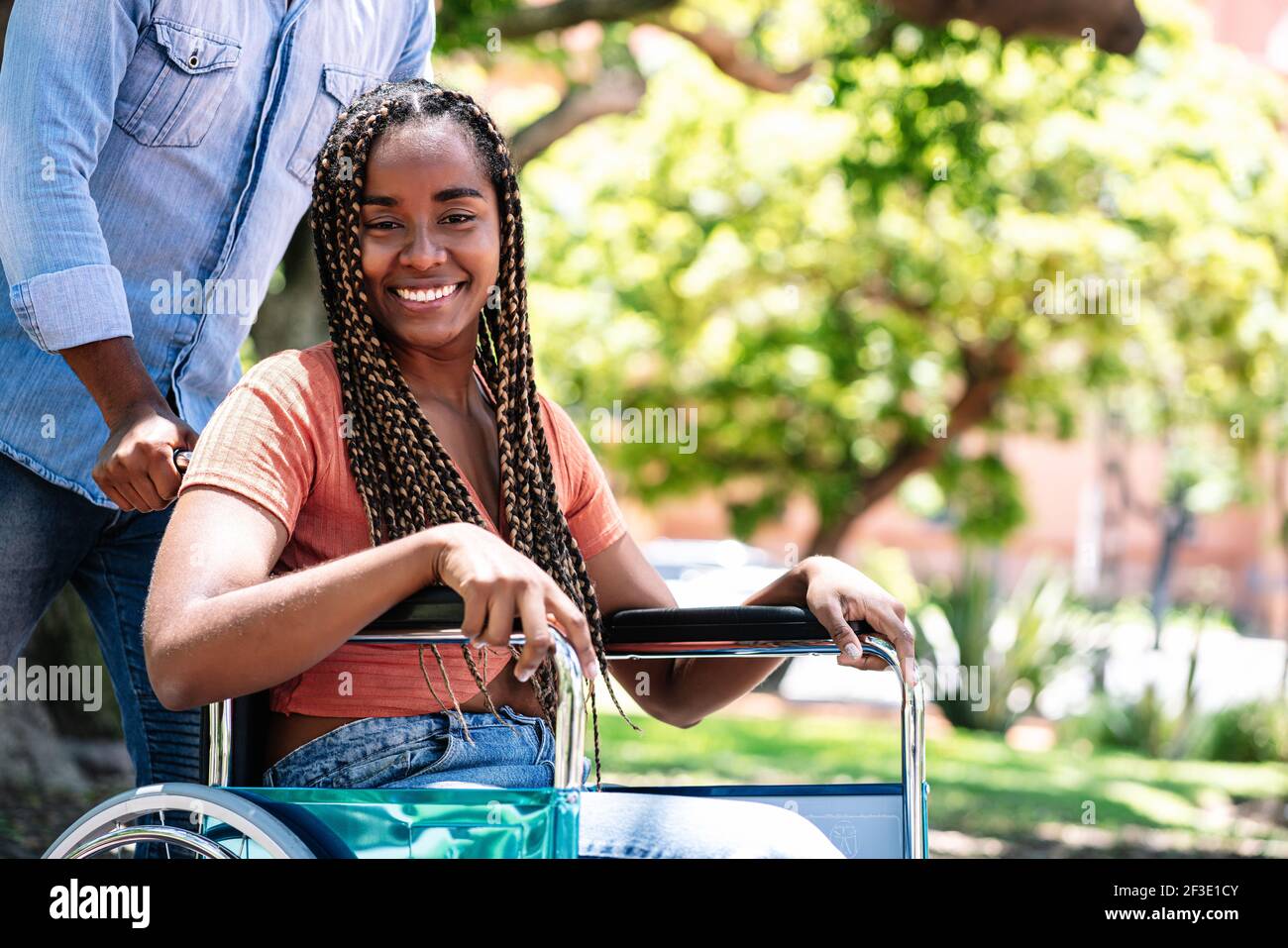 Woman in a wheelchair at the park with her boyfriend Stock Photo - Alamy