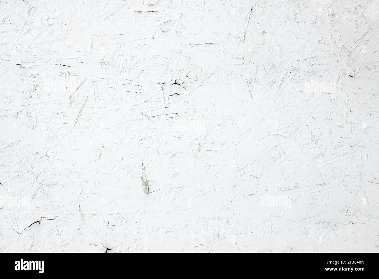 White painted plywood panel with peeling paint Stock Photo