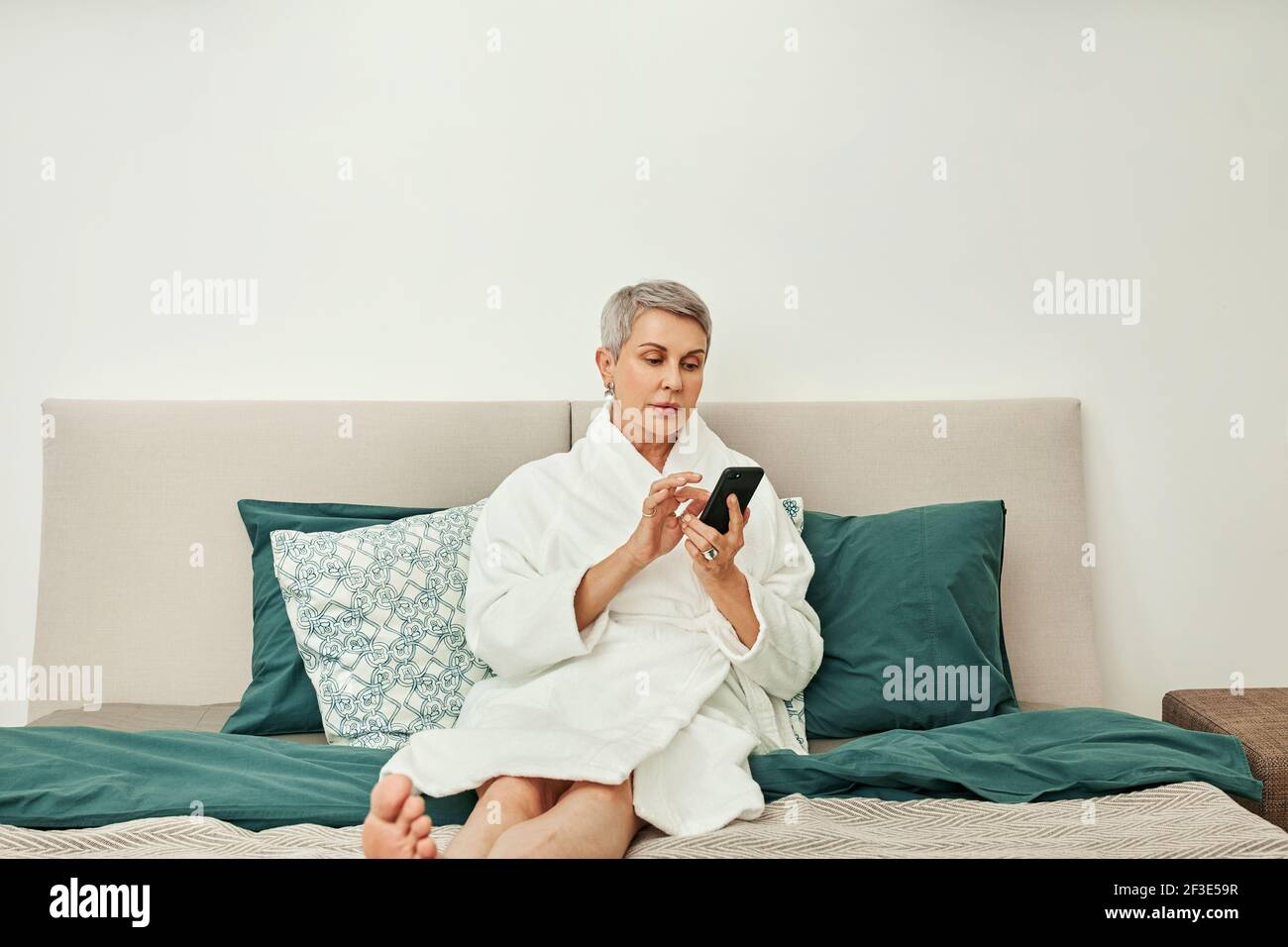 Mature woman smartphone typing hi-res stock photography and images - Alamy