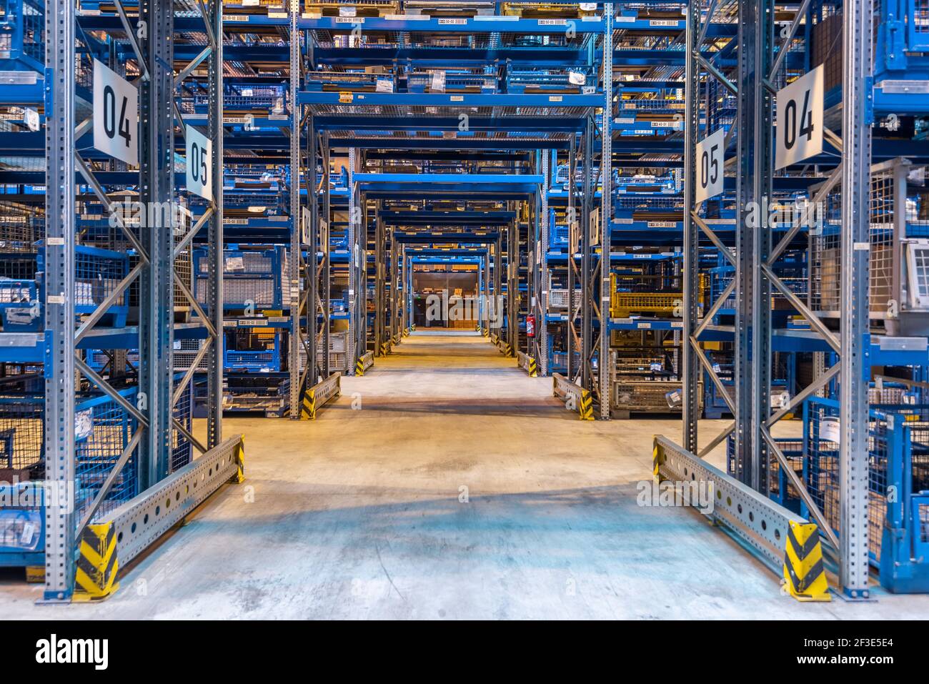 Forklift cross bridge aisle in racking system in modern distribution center warehouse. Transport and logistics concept. Stock Photo